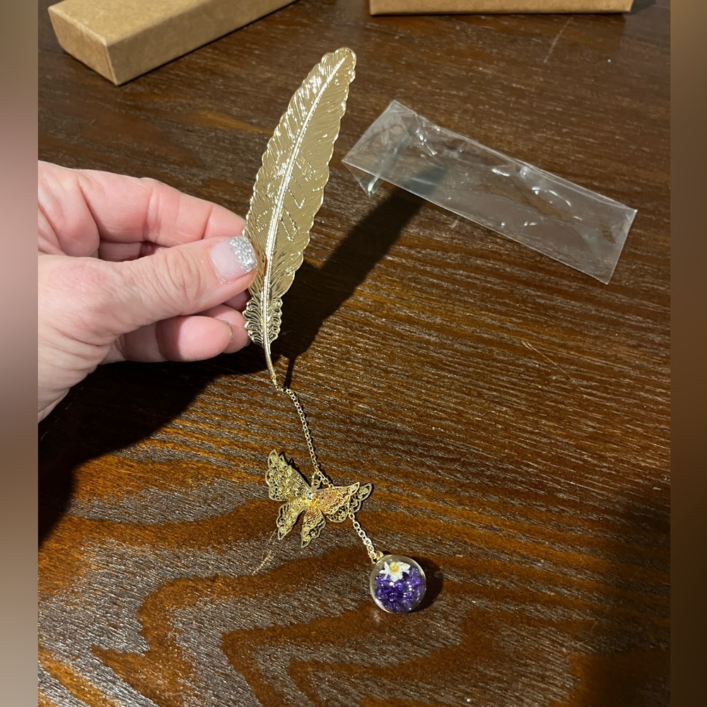 Hand made book mark w/ feather ball w/ purple jewels & white flower inside ball